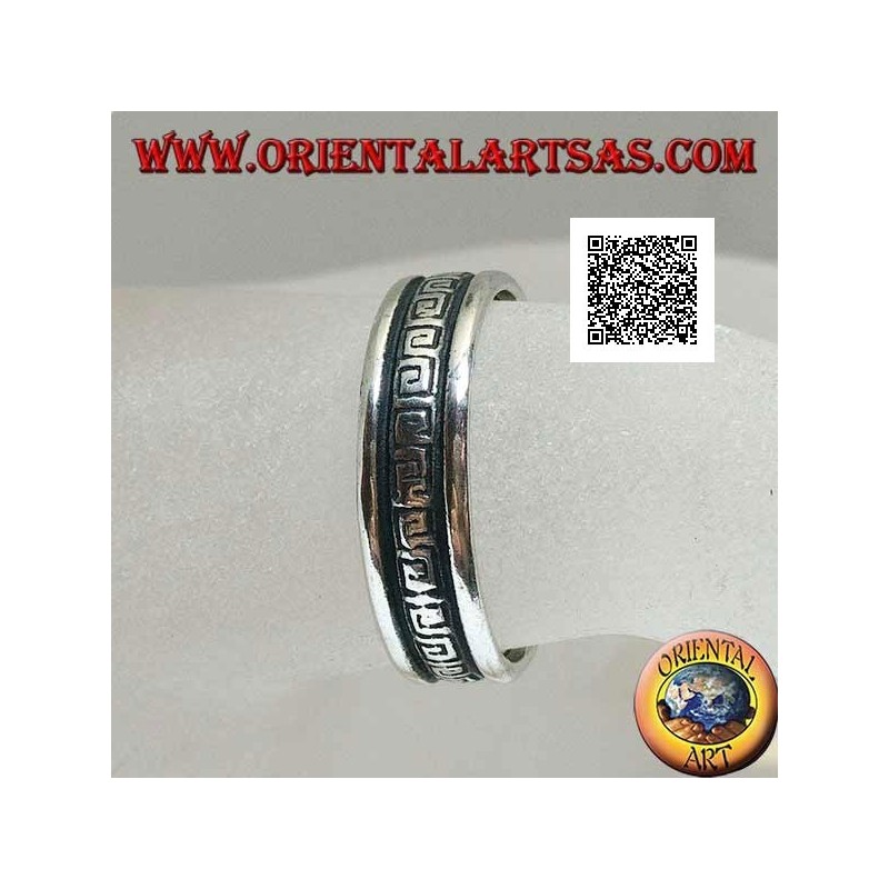 Silver wedding ring with a series of spiral labyrinths engraved in the central part