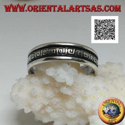 Silver wedding ring with a series of spiral labyrinths engraved in the central part