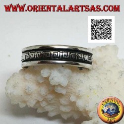 Silver wedding ring with a series of spiral labyrinths engraved in the central part