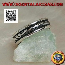 Silver wedding ring with a series of spiral labyrinths engraved in the central part