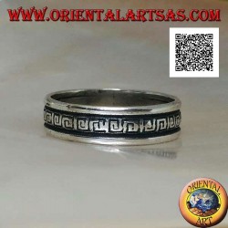 Silver wedding ring with a series of spiral labyrinths engraved in the central part