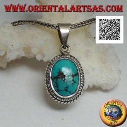 Silver pendant with antique oval Tibetan turquoise surrounded by a small and large double weave