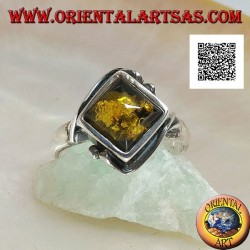Silver ring with square green amber mounted in a rhombus and two wires on the edges