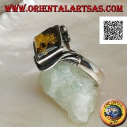 Silver ring with square green amber mounted in a rhombus and two wires on the edges