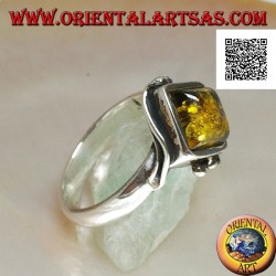 Silver ring with square green amber mounted in a rhombus and two wires on the edges