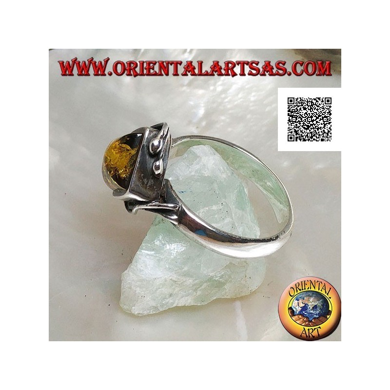 Silver ring with square green amber mounted in a rhombus and two wires on the edges