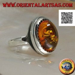 Silver ring with raised oval cabochon amber surrounded by triangles