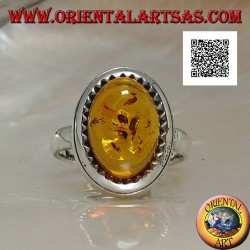 Silver ring with raised oval cabochon amber surrounded by triangles