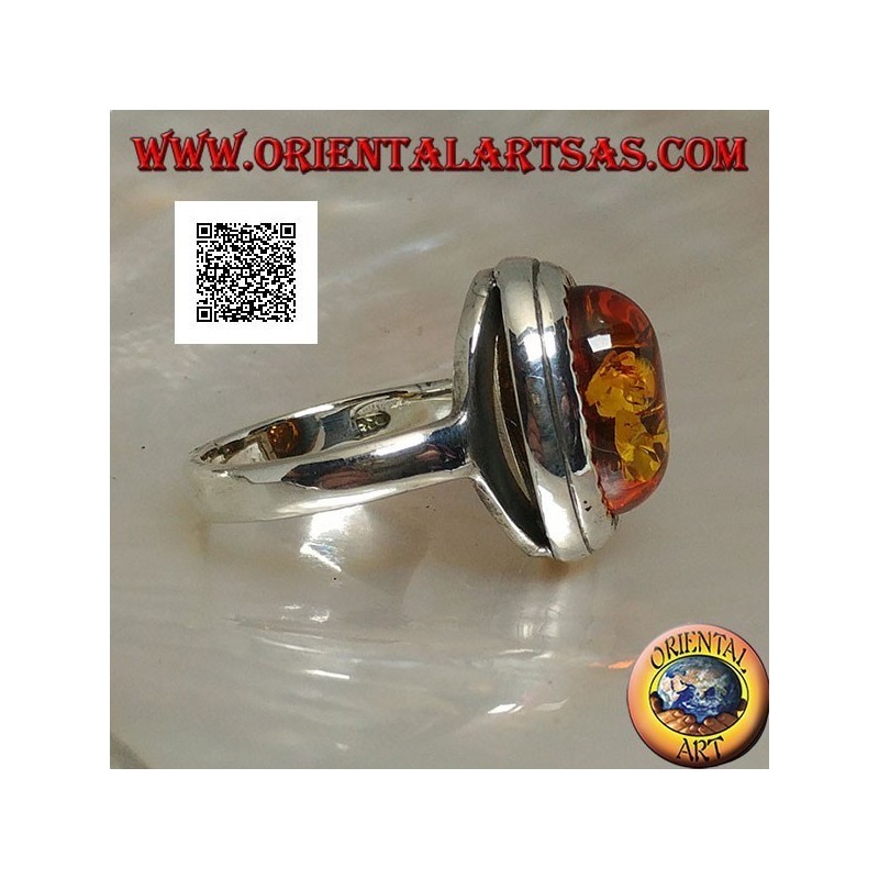 Anillo de plata con ámbar cabujón ovalado en relieve rodeado de triángulos