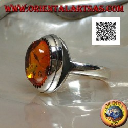 Silver ring with raised oval cabochon amber surrounded by triangles