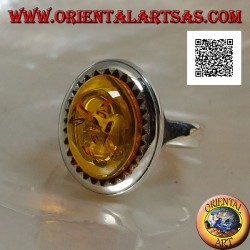 Silver ring with raised oval cabochon amber surrounded by triangles