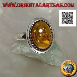 Silver ring with raised oval cabochon amber surrounded by triangles