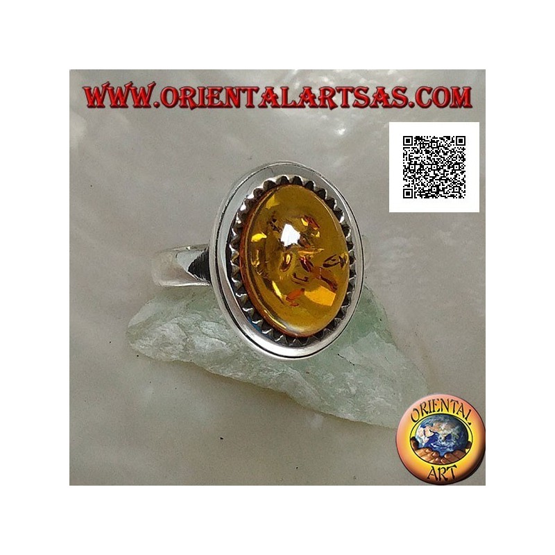 Silver ring with raised oval cabochon amber surrounded by triangles
