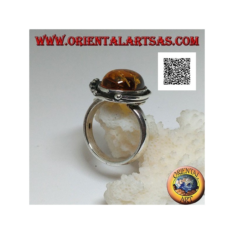 Silver ring with cabochon oval amber with two balls and a leaf on the edge