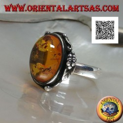 Silver ring with cabochon oval amber with two balls and a leaf on the edge