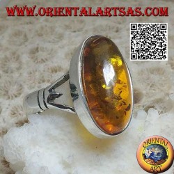 Silver ring with an elongated oval cabochon amber attached to two