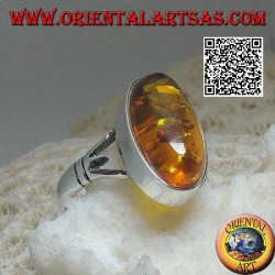 Silver ring with an elongated oval cabochon amber attached to two