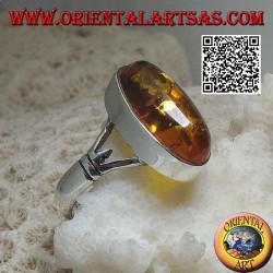 Silver ring with an elongated oval cabochon amber attached to two