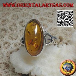 Silver ring with an elongated oval cabochon amber attached to two
