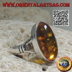 Silver ring with an elongated oval cabochon amber attached to two