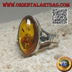 Silver ring with an elongated oval cabochon amber attached to two