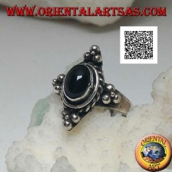 Silver ring with oval onyx surrounded by intertwining and trio of balls on the four cardinal points