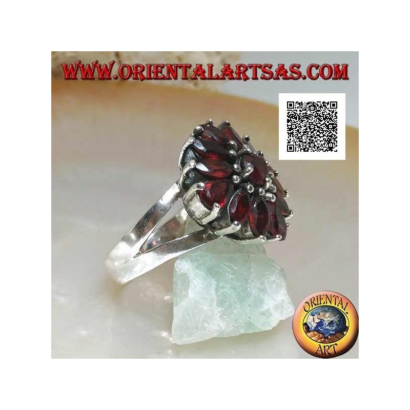 Silver ring with raised flower of 13 natural round, shuttle and drop shaped garnets, set