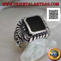 Silver ring with rectangular beveled onyx and curved lines pattern engraved in relief
