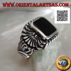Silver ring with rectangular beveled onyx and curved lines pattern engraved in relief
