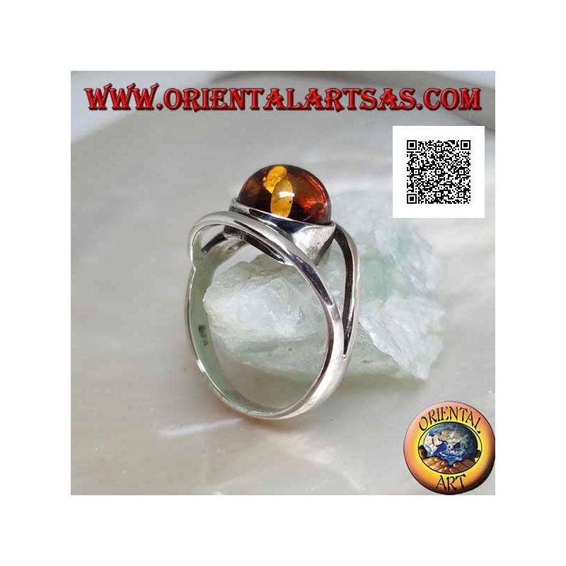 Silver ring with cabochon round amber between two curved lines in silver