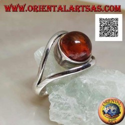Silver ring with cabochon round amber between two curved lines in silver