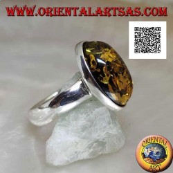 Silver ring with oval cabochon green amber on simple setting and smooth edge