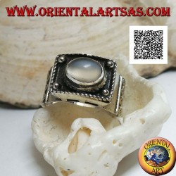 Silver band ring with raised cabochon oval moonstone and ethnic decorations