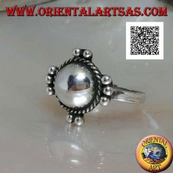 Silver ring with smooth hemisphere surrounded by intertwining and balls on the four cardinal points