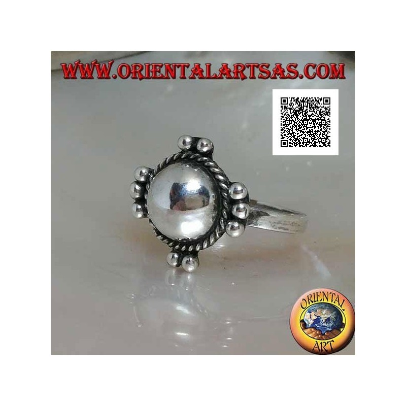 Silver ring with smooth hemisphere surrounded by intertwining and balls on the four cardinal points