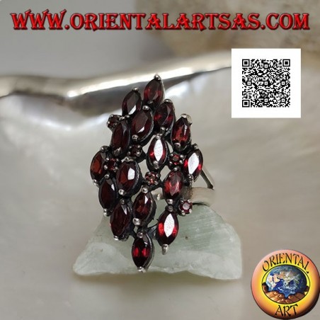 Rhomboidal silver ring with 16 shuttle garnets alternating with small round garnets