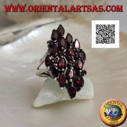 Rhomboidal silver ring with 16 shuttle garnets alternating with small round garnets