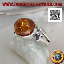 Silver ring with oval cabochon amber crosswise with elongated triangular hole
