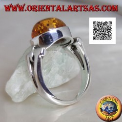 Silver ring with oval cabochon amber crosswise with elongated triangular hole