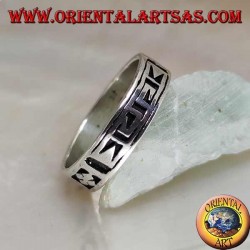 Silver ring with a geometric motif between stylized dorje engraved twice