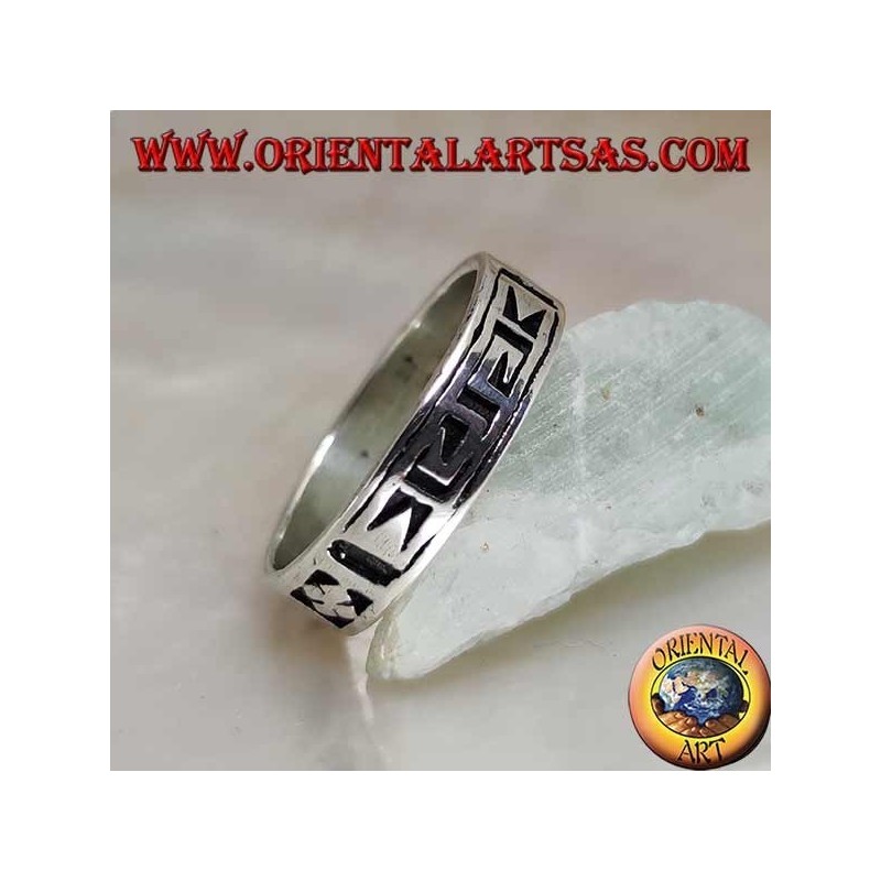 Silver ring with a geometric motif between stylized dorje engraved twice
