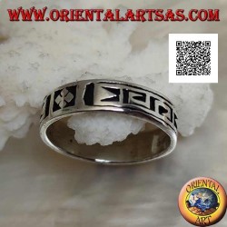 Silver ring with a geometric motif between stylized dorje engraved twice
