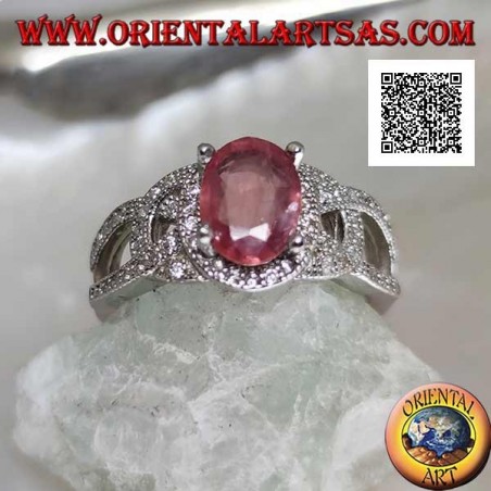 Silver ring with natural oval ruby set between wavy intersecting lines studded with zircons