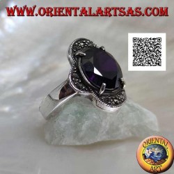 Silver ring with oval amethyst set between four semicircles studded with marcasite