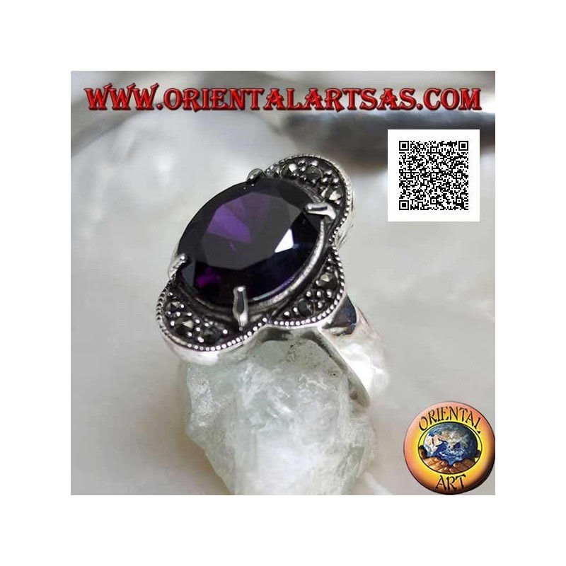 Silver ring with oval amethyst set between four semicircles studded with marcasite