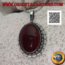 Silver pendant with large oval cabochon carnelian surrounded by trio of balls and studs