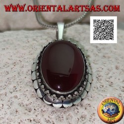 Silver pendant with large oval cabochon carnelian surrounded by trio of balls and studs