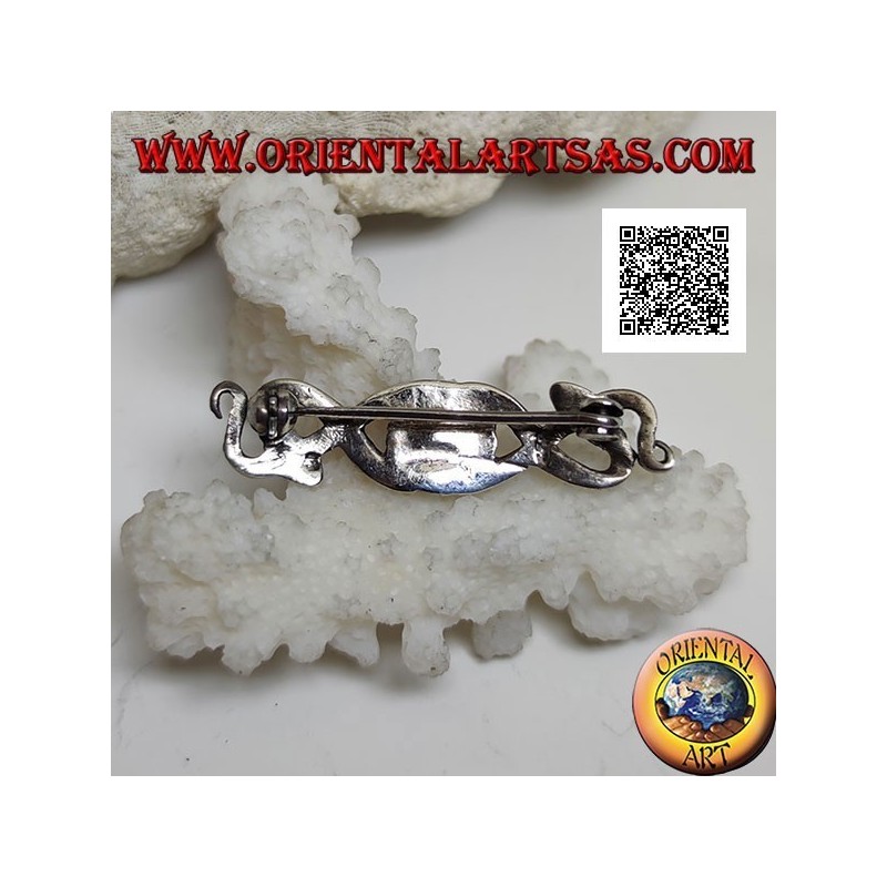 Broche de plata en forma de dos serpientes entrelazadas con ónix central y en los ojos