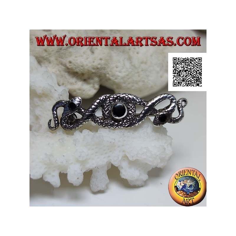 Broche de plata en forma de dos serpientes entrelazadas con ónix central y en los ojos
