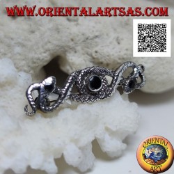 Silver brooch in the shape of two snakes intertwined with central onyx and on the eyes